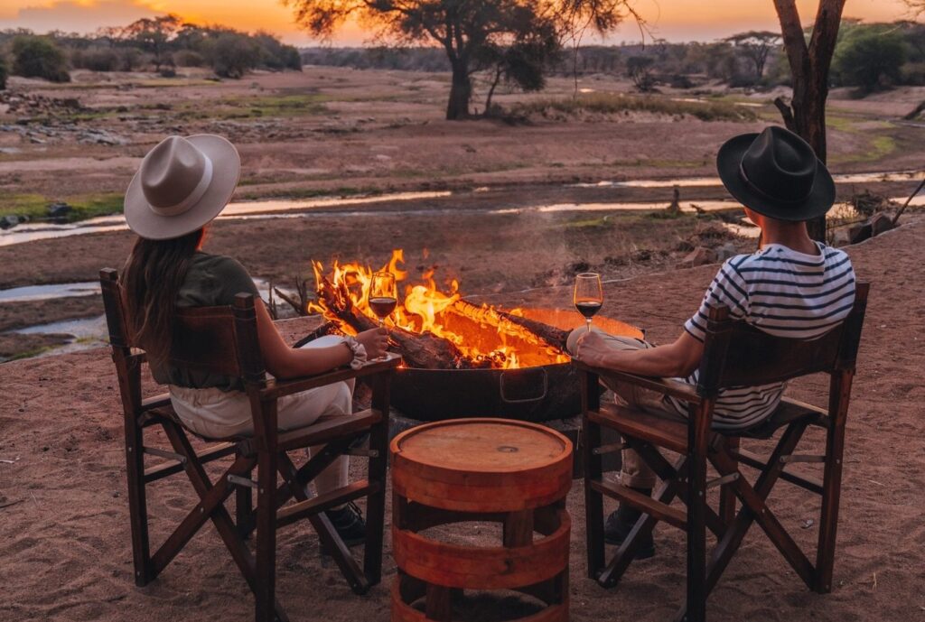 honeymooners-sits-by-firepit-on-honeymoon-safari-tanzania